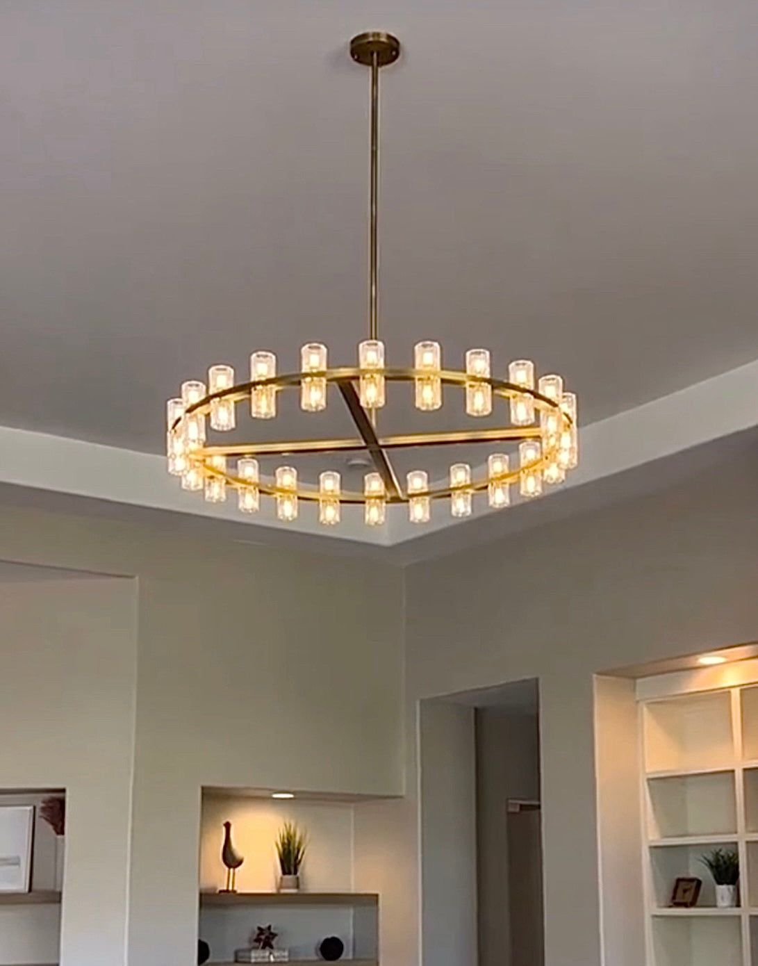 The rhythmic design of this chandelier collection is inspired by the shape and scale of industrial gears, where spokes are interlaced with negative space to interlock with other gears. Here, the spokes are hexagonal in form, juxtaposed with a circular interior, crafted from crystal glass, running along a simple, sturdy metal frame. The light shines through the glass as if it were a candle.